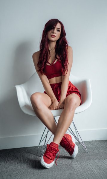 A-woman-with-long-burgundy-hair-wearing-a-red-crop-1