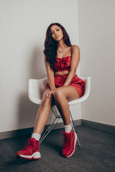 A-woman-with-long-burgundy-hair-wearing-a-red-crop