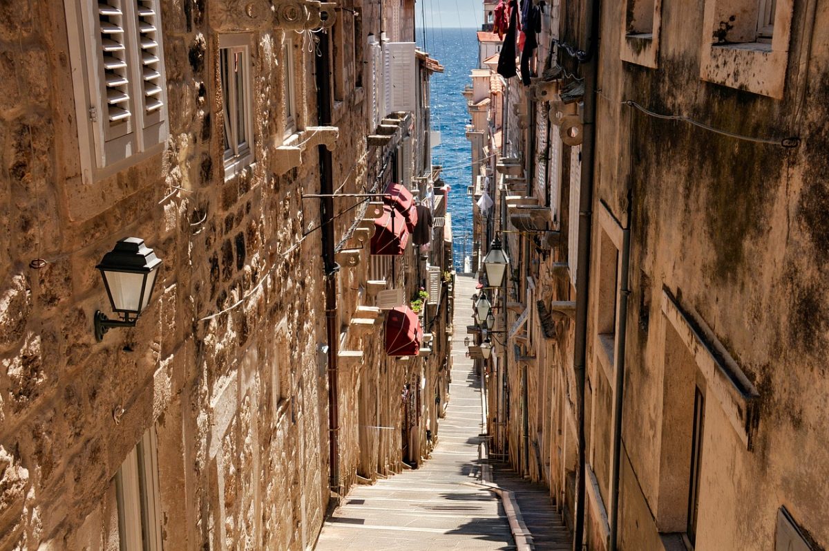 europe, tourism, italy, city, history, architecture, sea, summer, beach, old street, fortress, steps, street lamps, shade, balcony, blue sky, destination, walk, masonry, tourist attraction