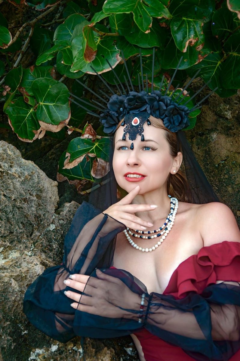black crown, gothic style, fashion, tropical, beautiful, jewelry, modeling, femininity, beach, posing, numerous, jewel, red dress, vacation, green foliage, photography, bottle, beach style, gemstone, bodice