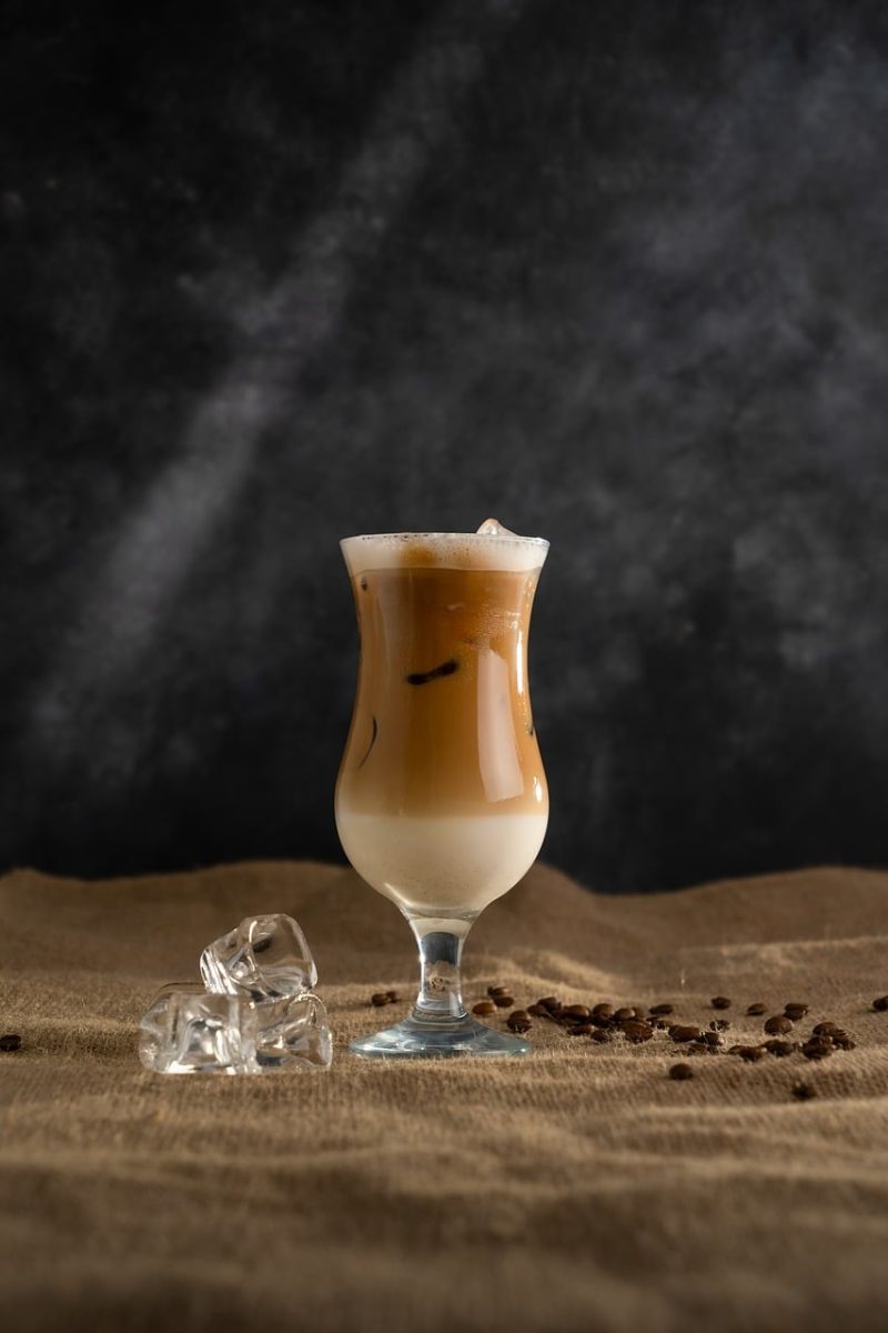 iced coffee, cold drink, coffee bean, ice, glass, beverage, table, cafe vibe, coffee with milk, foam, brown color, burlap, light brown tones, contrast, black background, artistic photography, still life, winter drink