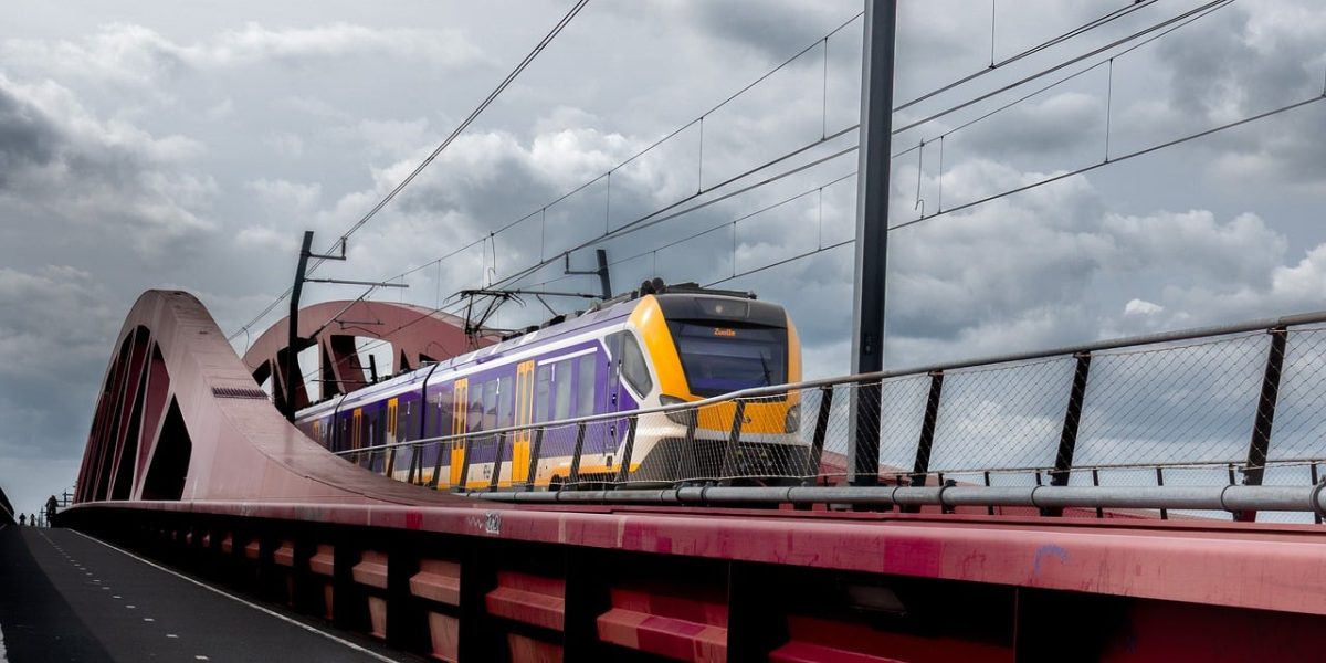 railway bridge, train, red, clouds, netherlands, modern architecture, commuter train, nature, travel, infrastructure, urban, dramatic sky, railway, river, transportation, passenger, yellow, concrete, bridge design, bridge construction
