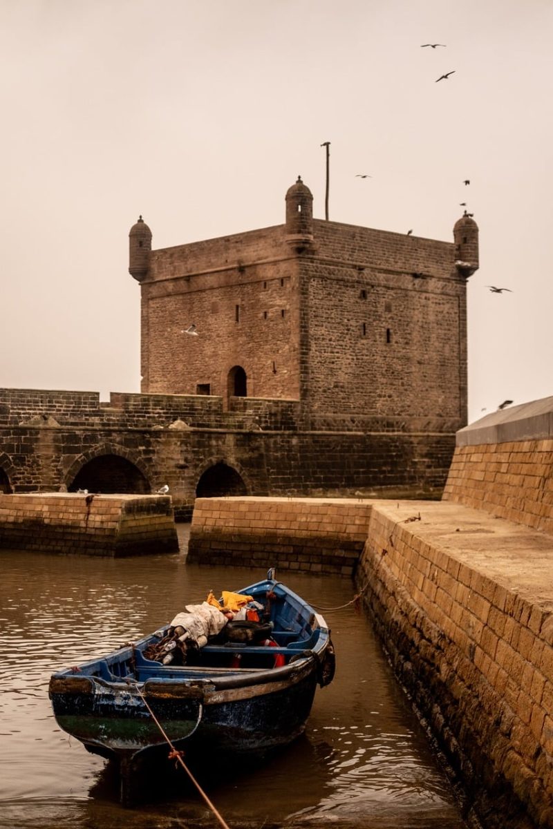 boat, harbor, fortress, fishing gear, old town, wall, ancient architecture, seagull, waterway, sea, stone structure, enclosure, sunset, tide, view, historic site, fishing harbor, nature, ocean view, historic building, harbor view