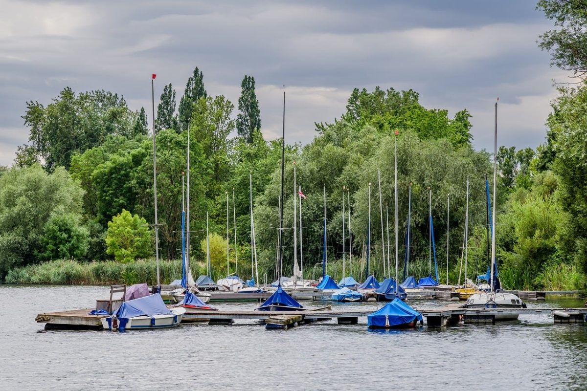 yacht, lake, sailboat, dock, forest, trees, nature, boating, tranquility, relaxation, summer, outdoors, boat, park, tree line, picnic, water surface, moored, green, cloudy