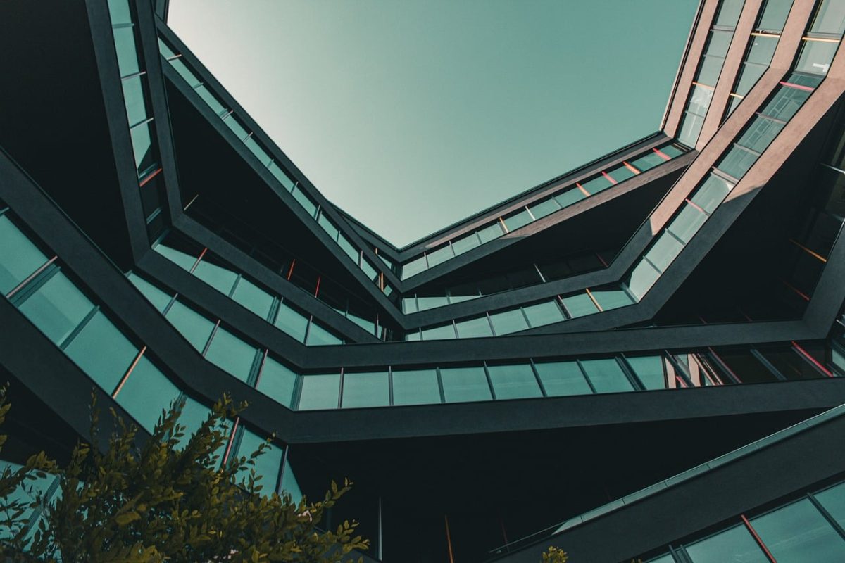 modern architecture, urban view, architectural design, multi-angular building, long angle view, blue sky, office building, modern city, abstract architecture, minimalist aesthetics, skyscraper, light reflection, urban architecture, geometric patterns, window facade, urban environment, building structure, outdoor view, building construction, modern offices