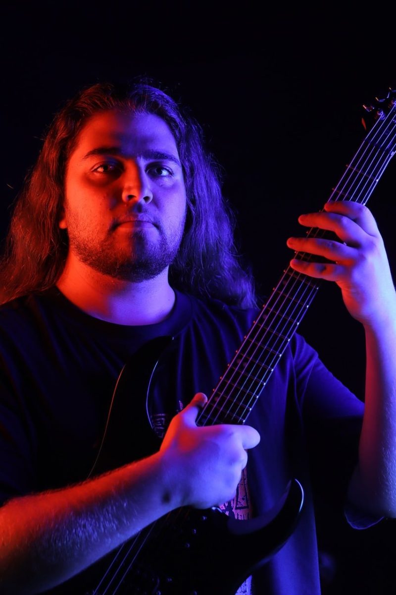 portrait, musician, electric guitar, blue light, purple light, dramatic lighting, dark background, studio portrait, moody, long hair, thematic, artist, creative photography, colorful lighting, male portrait, music artist, creative, male