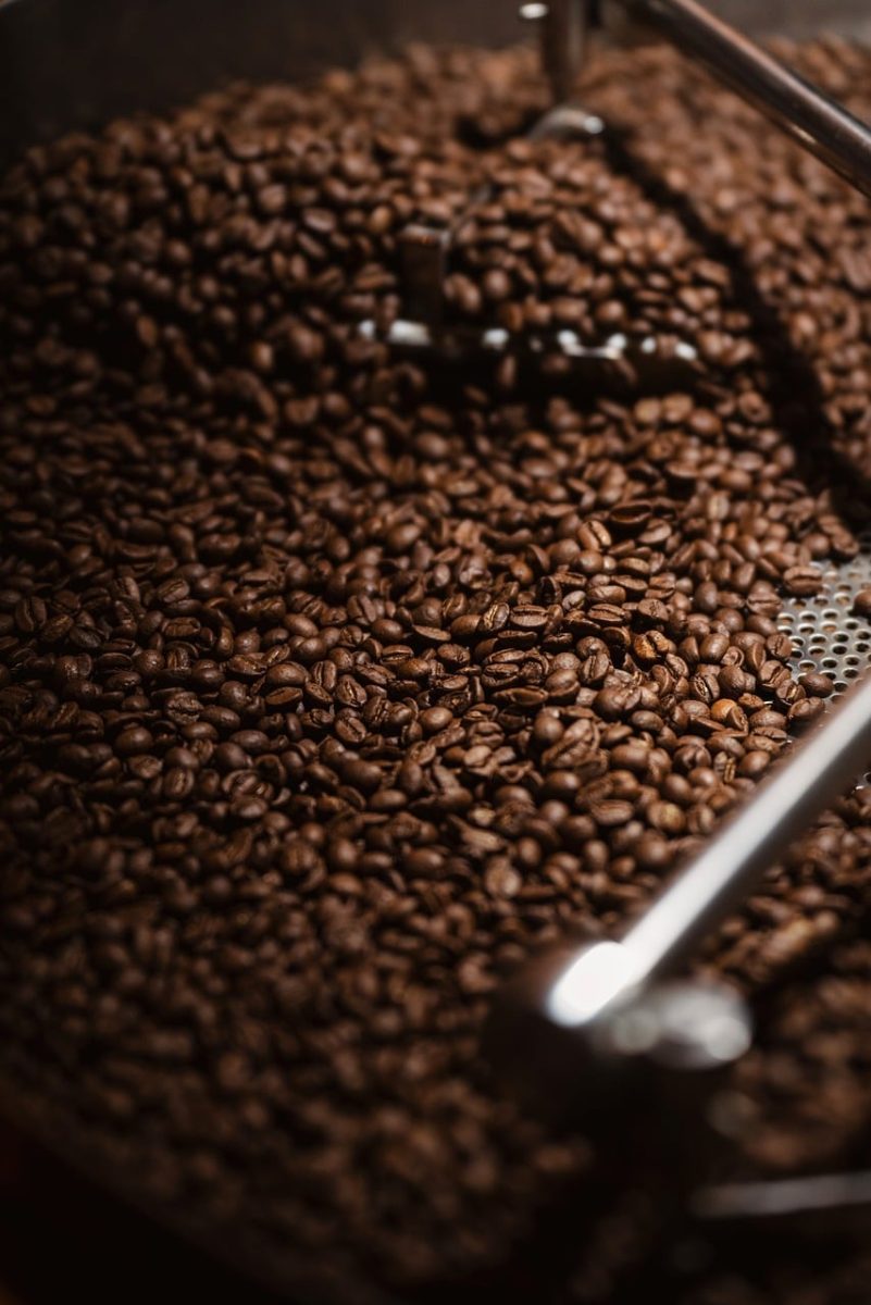 coffee beans, roasted beans, industrial roasting, warm lighting, selective focus, cooling bed, metal agitator, macro composition, phone wallpaper, deep brown, close up texture, coffee processing, high resolution, iphone wallpaper, beautiful wallpaper, production line, background, dark roast coffee, austria, bulk roasting