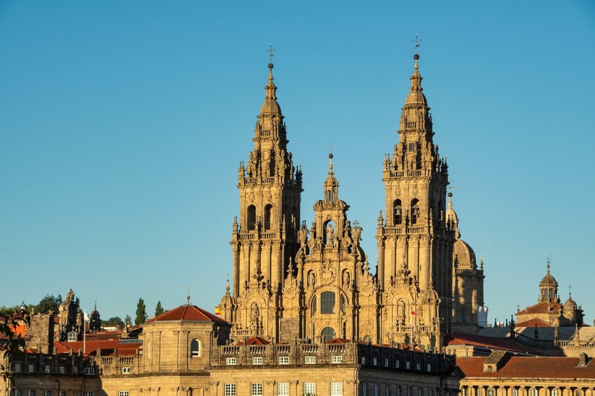 cathedral, santiago de compostela, architecture, historic, landmark, unesco, sun, medieval, tower, rooftops, stone, history, world heritage, clear sky, tourism, pilgrimage site, square, facade, baroque, tourist attraction