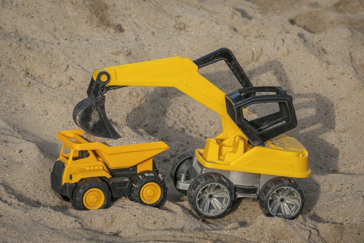 toy, excavator, sand, dumper, playing in sand, yellow color, construction site, kids' play, model, outdoor activity, building, beach toys, child's imagination, toy vehicles, outdoor play, wheels, small vehicle, interactive play, kids' excavator, play set