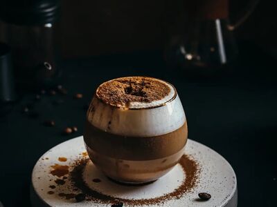 coffee, espresso, foamy drink, glass cup, cocoa powder, black surface, lighting, macro, coffee beans, coffee maker, elegant, artistic, atmospheric, chemex coffee maker, aesthetic, minimalistic, no description available, cocoa texture, culinary culture, appearance