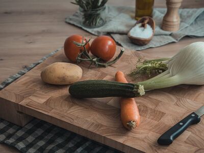 cooking, natural, wooden board, carrot, zucchini, potato, tomato, fennel, knife, olive oil, pepper, salt, herb, food preparation, table setting, kitchen utensil, home cooking, healthy eating, outdoor picnic, rustic kitchen