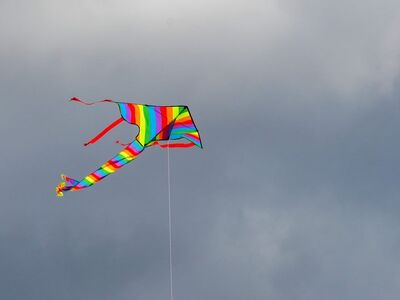 kite, rainbow, flying, wind, sky, summer, leisure, fun, blue, cloud, colorful, playful, tail, outdoor, kite shape, lightweight, freedom, simple, spirit, happy