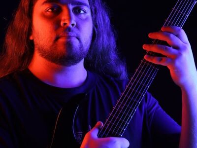 portrait, musician, electric guitar, blue light, purple light, dramatic lighting, dark background, studio portrait, moody, long hair, thematic, artist, creative photography, colorful lighting, male portrait, music artist, creative, male