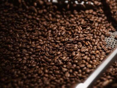 coffee beans, roasted beans, industrial roasting, warm lighting, selective focus, cooling bed, metal agitator, macro composition, phone wallpaper, deep brown, close up texture, coffee processing, high resolution, iphone wallpaper, beautiful wallpaper, production line, background, dark roast coffee, austria, bulk roasting