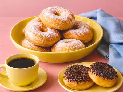 donuts, chocolate sprinkles, yellow dishes, sweet treat, breakfast, pastry, cup of coffee, snack, indonesian pastry, coffee beverage, powdered sugar, cake, serving platter, baking, homemade, blue fabric, fresh, dessert
