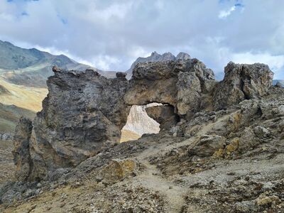 rock, natural bridge, mountains, clouds, sky, hiking, nature, desert, natural formation, geology, pathway, travel, adventure, stones, climate, aridity, rock arch, panorama, monument
