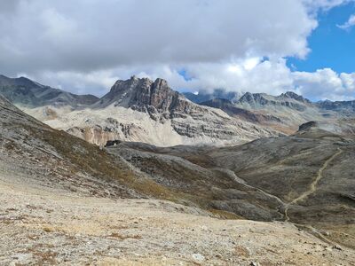 alps, mountains, high alpine, view, scree, mountain peak, path, mountain path, mountain pass, stones, mountain massif, hiking, sky, clouds, nature, panorama, tourist destination, landscape portrait, leisurely hike, wilderness, nature excursion