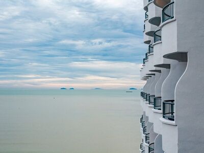 penang, malaysia, coastal building, curved balcony, sea landscape, calm sea, nature, distant islands, cloudy sky, architecture photography, modern architecture, sea view, extreme angle, luxury hotel, ocean, clear sky, coast, tranquility