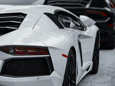 cars, super cars, luxury cars, lamborghini, corvette, black car, white car, sports cars, exotic cars, daytime, parked cars, car row, black lamborghini, white lamborghini, black corvette, high-end vehicles, automobile, car collection, outdoor