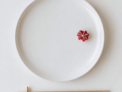 japanese new year, minimal, white plate, chopsticks, gold chopstick rest, mizuhiki, red decoration, flat lay, top view, clean, modern, celebration, copy space, zen, neutral, high resolution, food background, postcard, design template, table setting