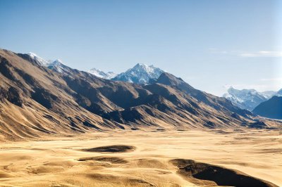 mountains, sand desert, snowcapped peaks, valley, blue sky, desert, mountain foothills, trees, view, natural landscape, landscape, sun, dry, shadows, summer, sunny, sky, sand, natural beauty, travel destination, tranquility