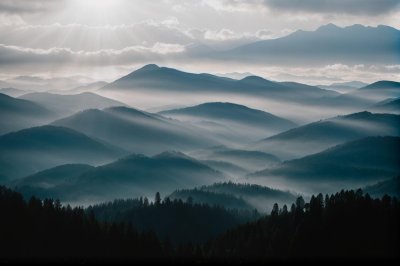 misty mountains, sunbeams, mountain landscape, layered ridges, dramatic clouds, atmospheric light, early morning, silhouette forest, soft haze, serene nature