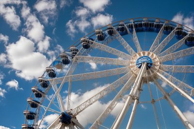 ferris wheel, blue sky, clouds, entertainment, fair, kids ride, amusement park, aerial view, festival, celebrations, nature, fun ride, carousel, sky, giant wheel, festive event, school trip, satisfaction, excitement, time of day, magic of the moment