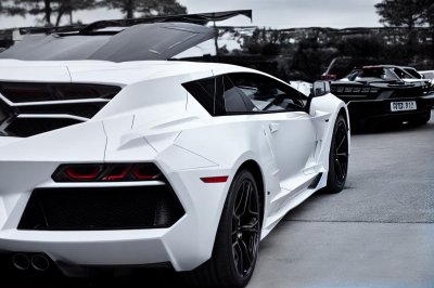 super cars, luxury cars, lamborghini, corvette, black car, white car, sports cars, exotic cars, car photography, daytime, parked cars, black lamborghini, white lamborghini, black corvette, high-end vehicles, automobile, car collection, outdoor, sunny day